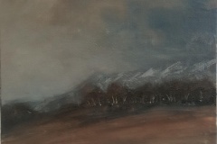 Trees before mountain range